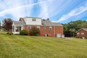 18 Ellen Drive McKees Rocks, PA 15136 - Photo 3 of 23 a front view of a house with a yard and garage