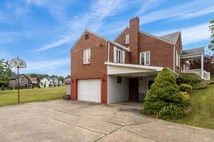 18 Ellen Drive McKees Rocks, PA 15136 - Photo 5 of 23 a front view of a house with a yard and garage
