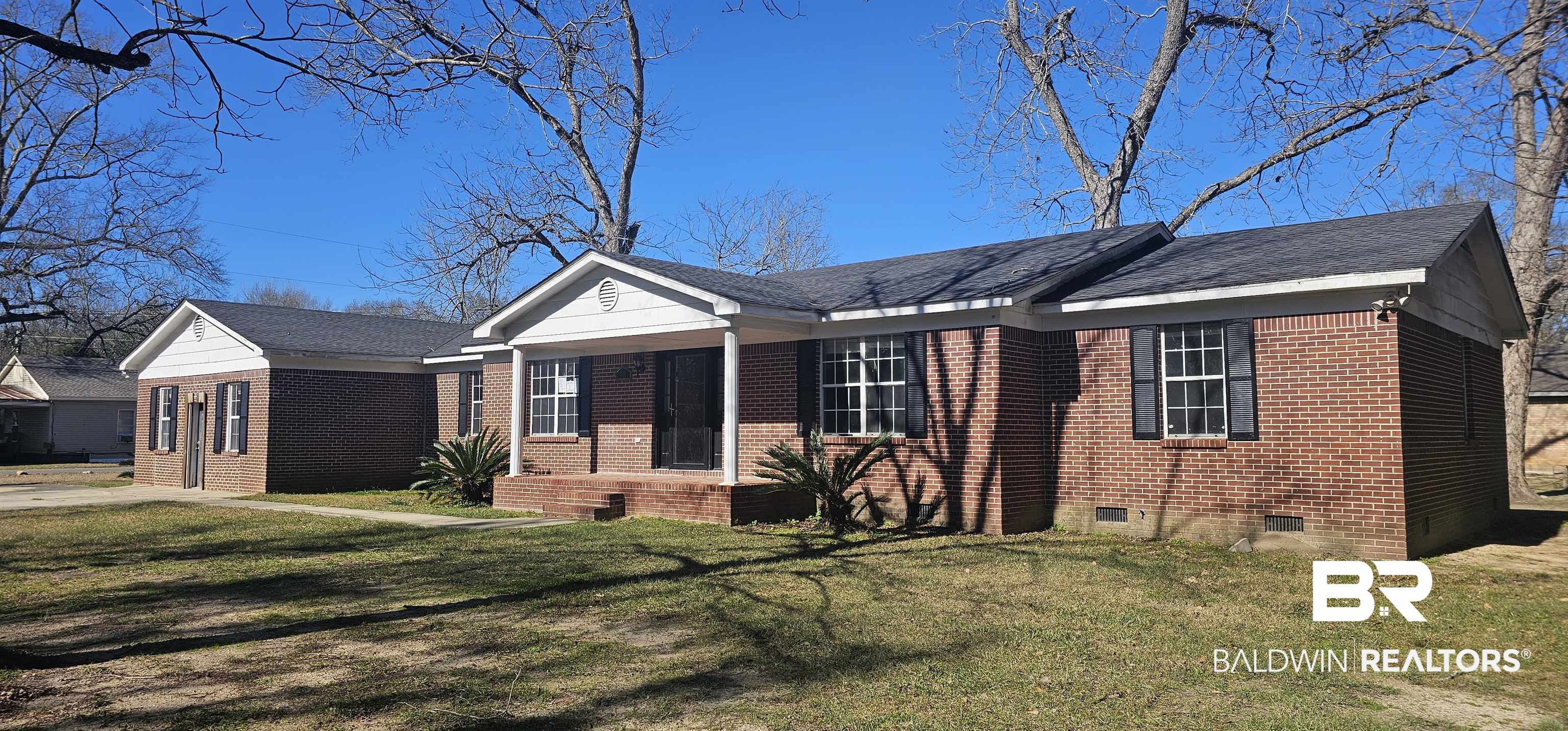 151 Bullard Street Atmore, AL 36502 - Photo 1 of 38 Ranch-style house featuring a front yard, brick siding, a shingled roof, and crawl space