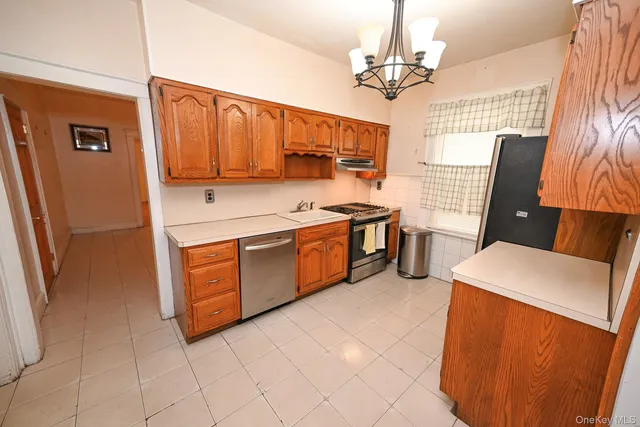 an empty room with a window and wooden floor