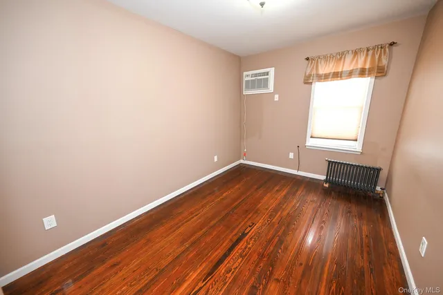 a view of wooden floor in an empty room