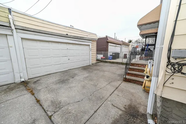 a view of a house with a yard and parking space