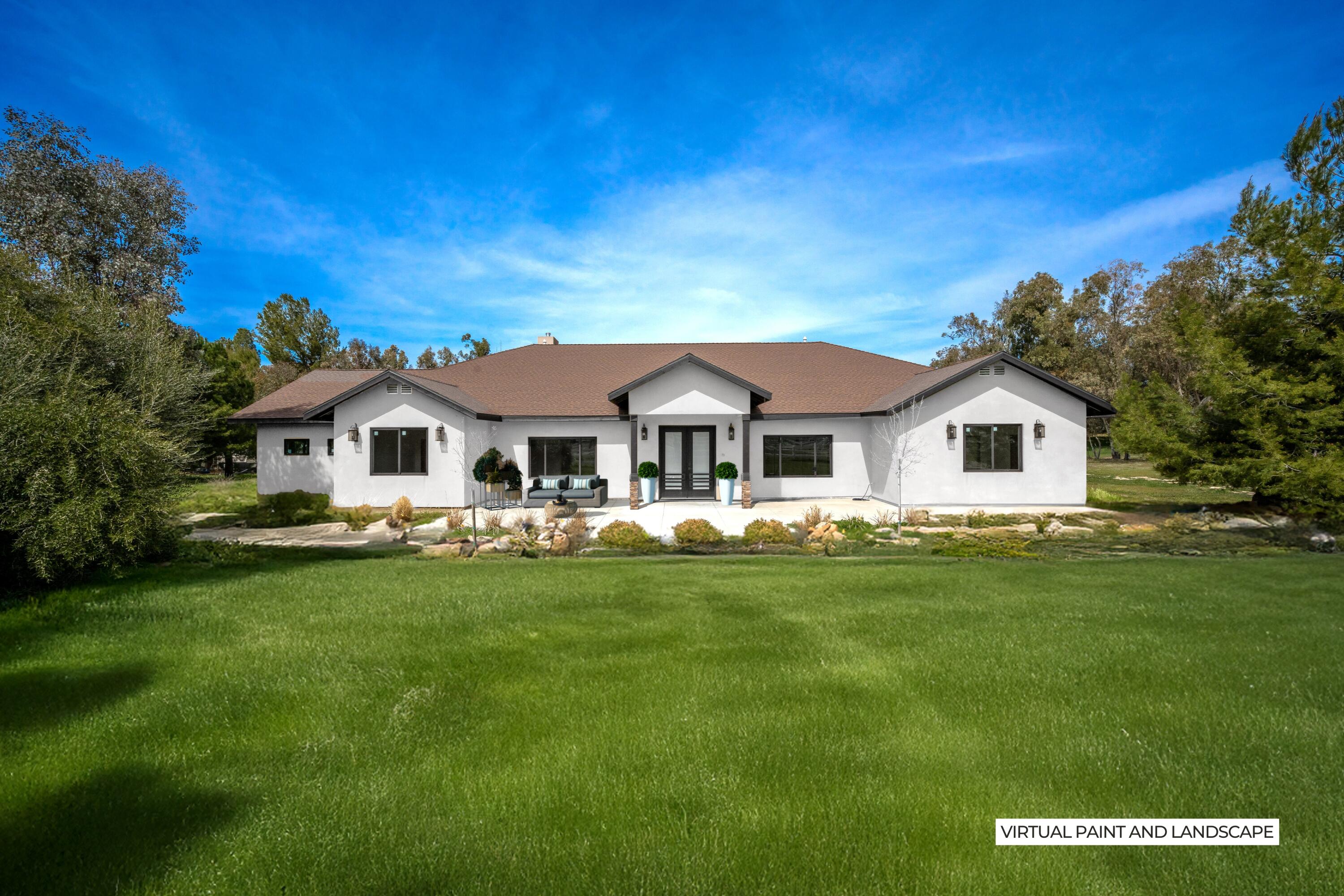 17370 Rodeo Road Lake Elsinore, CA 92530 - Photo 2 of 68 a white house with a big yard and potted plants in front of it