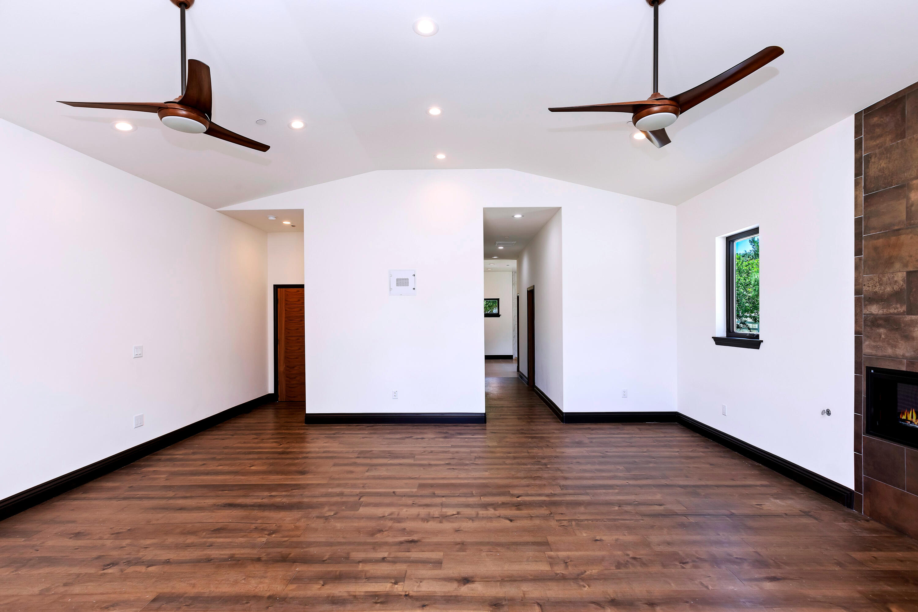 17370 Rodeo Road Lake Elsinore, CA 92530 - Photo 33 of 68 a view of an empty room with wooden floor and a ceiling fan
