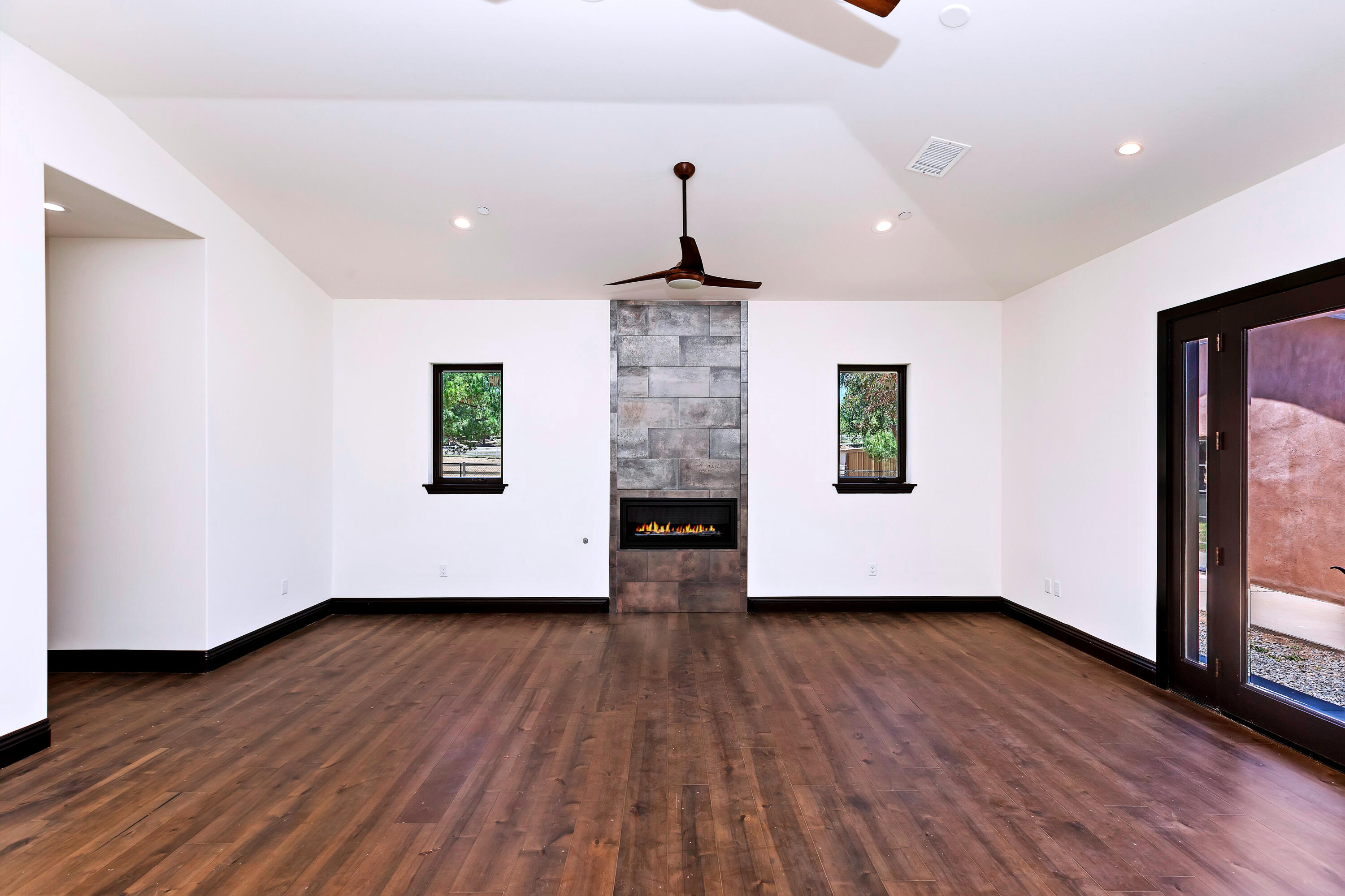 17370 Rodeo Road Lake Elsinore, CA 92530 - Photo 34 of 68 a big room with wooden floor fireplace and windows