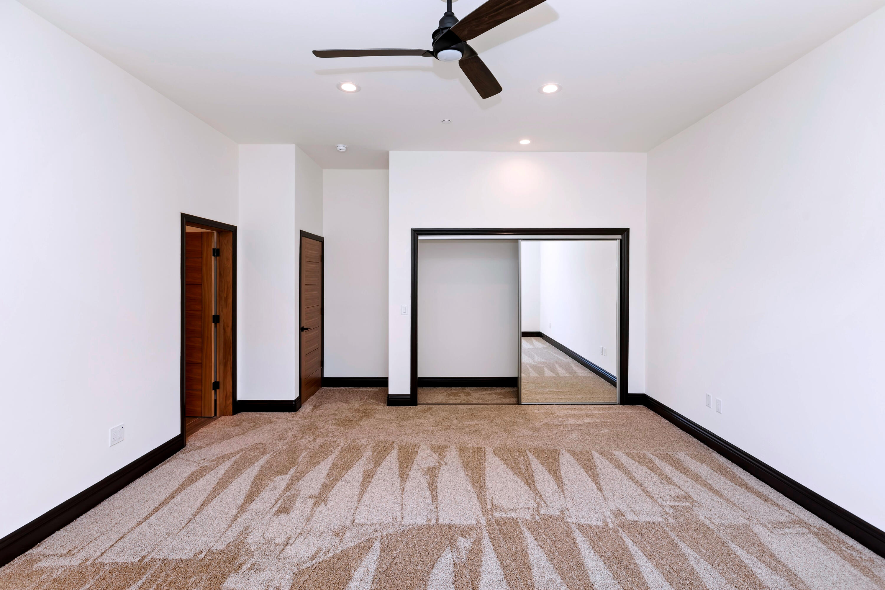 17370 Rodeo Road Lake Elsinore, CA 92530 - Photo 41 of 68 a view of an empty room with wooden floor and ceiling fan