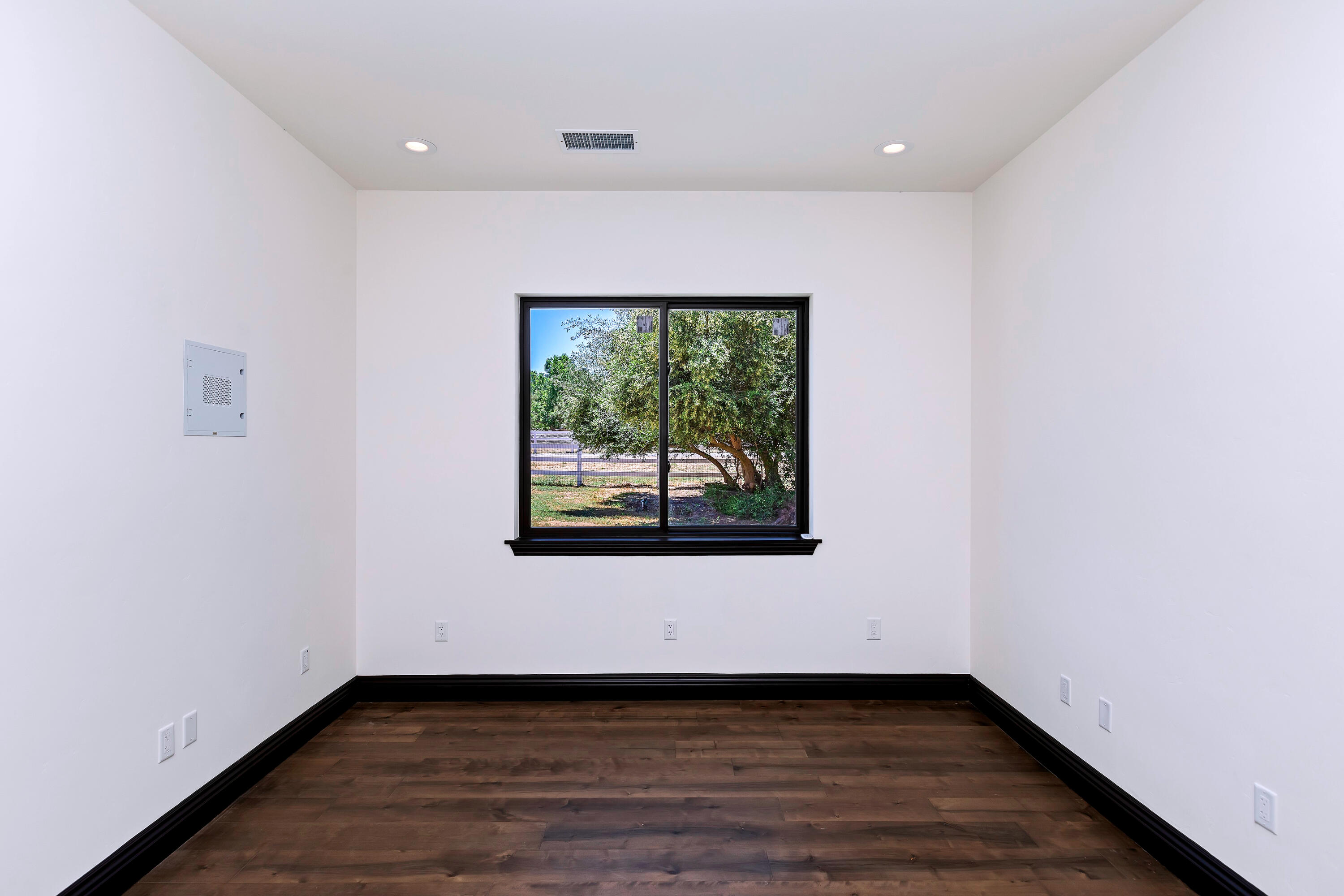 17370 Rodeo Road Lake Elsinore, CA 92530 - Photo 47 of 68 an empty room with wooden floor and windows