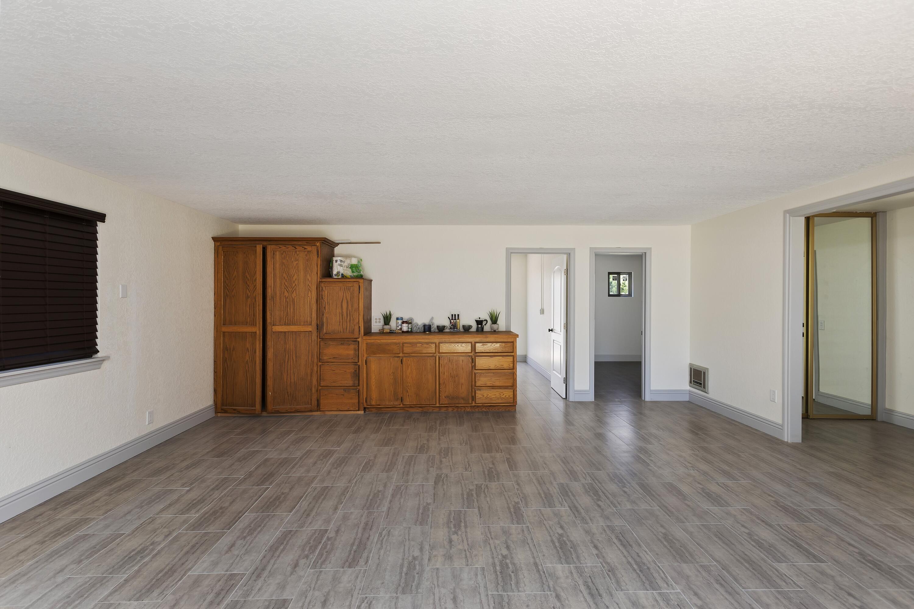 17370 Rodeo Road Lake Elsinore, CA 92530 - Photo 59 of 68 a view of an empty room with wooden floor and a window