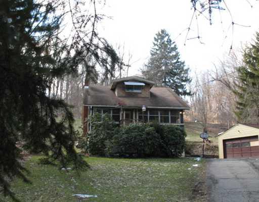 Exterior Front. 1.5 Story house on nearly 1 acre in private setting. Exterior needs your TLC.**Subject to lender approval for a Short Sale** A true bargain in Shaler School District...Bank wants offers. Must visit and consider this opportunity.