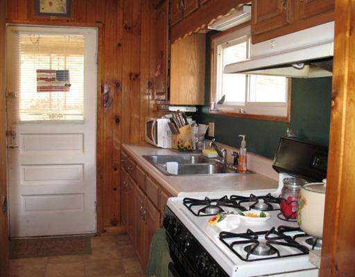 327 Wible Run Road Pittsburgh, PA 15209 - Photo 6 of 18 Kitchen. Kitchen has been updated to include vinly replacement window, oak cabinets, Stainless steel double sink, nuetral vinly tile floor and counter.