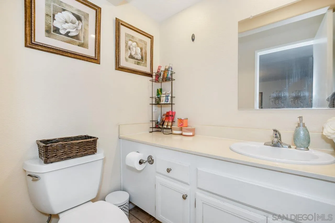 1458 Summit Drive Chula Vista, CA 91910 - Photo 14 of 22 a bathroom with a toilet a sink and a mirror