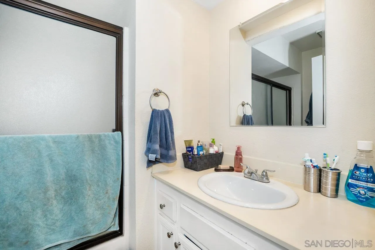 1458 Summit Drive Chula Vista, CA 91910 - Photo 16 of 22 a bathroom with a sink vanity and a mirror