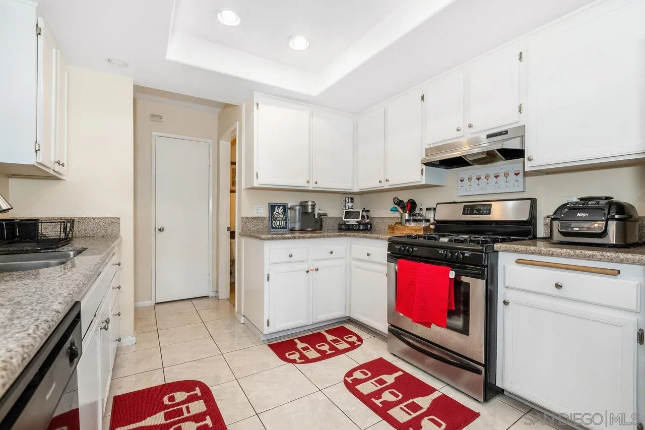1458 Summit Drive Chula Vista, CA 91910 - Photo 7 of 22 a kitchen with stainless steel appliances granite countertop a stove a sink and a refrigerator