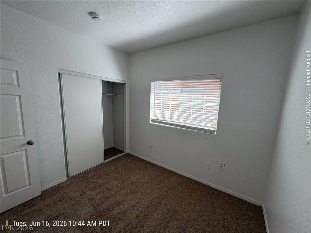4730 East Craig Road, Unit 1124 Las Vegas, NV 89115 - Photo 21 of 22 A well-lit bedroom features plush carpeting and convenient sliding closet doors.