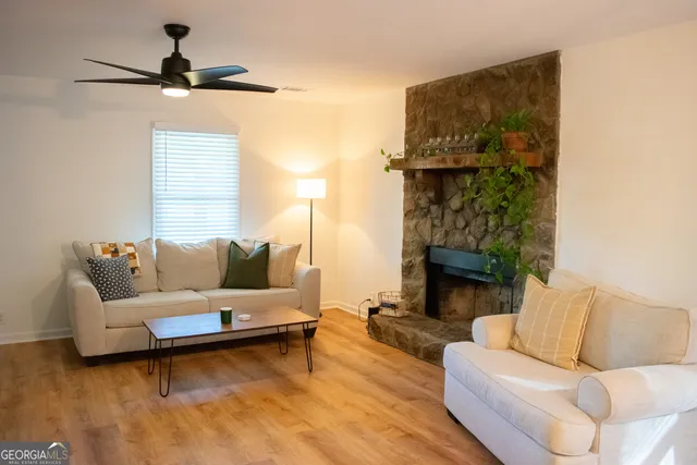 a view of a hallway with wooden floor and windows
