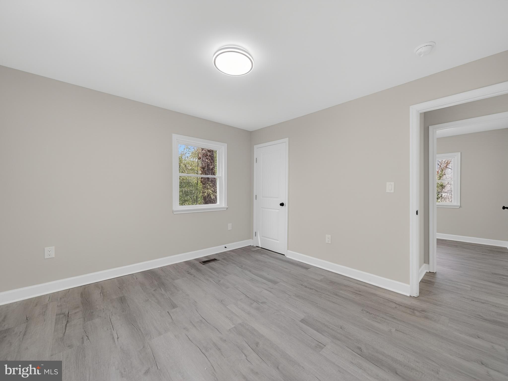 4475 Virginia Avenue Prince Frederick, MD 20678 - Photo 23 of 51 an empty room with wooden floor and windows