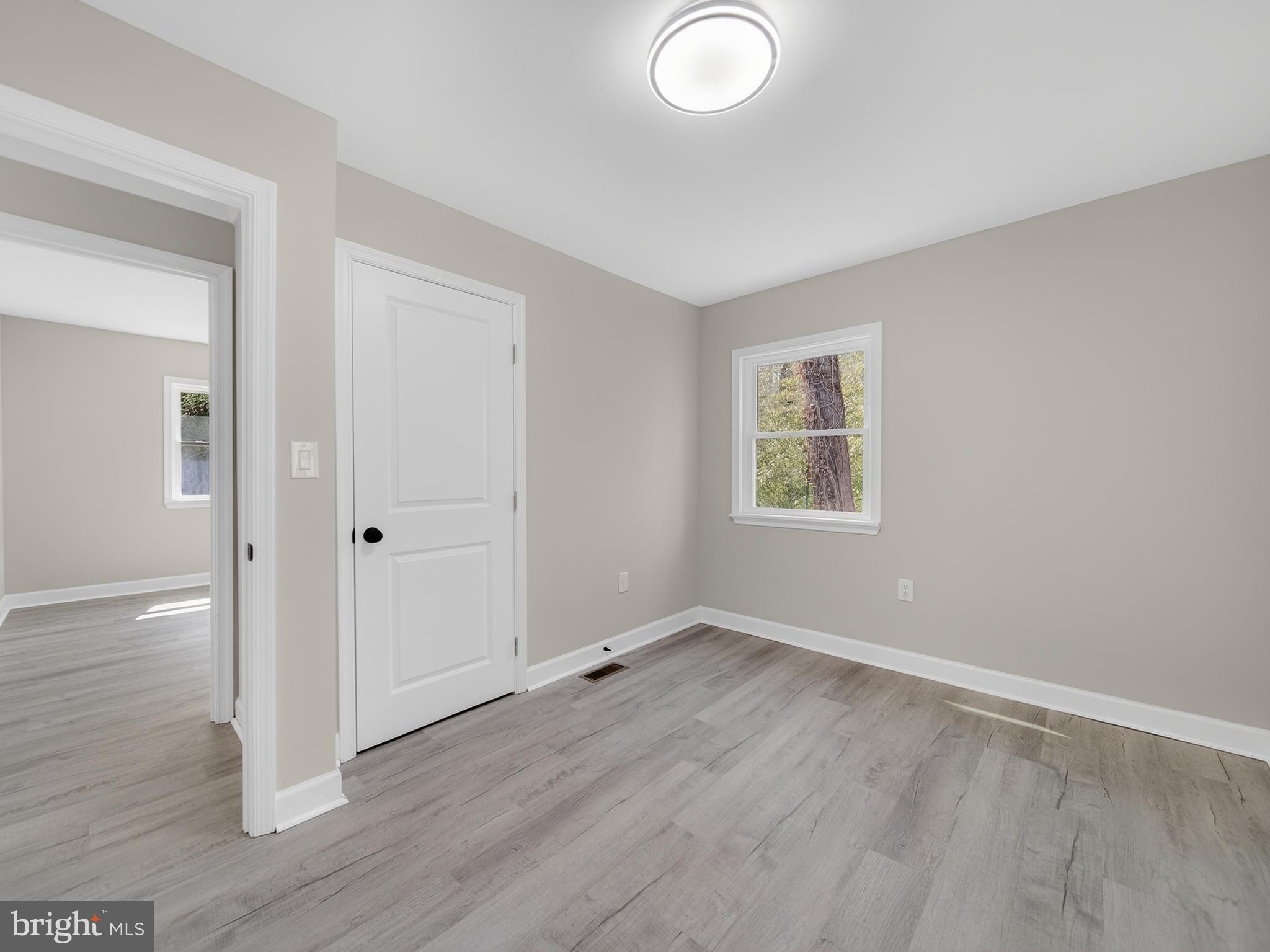 4475 Virginia Avenue Prince Frederick, MD 20678 - Photo 29 of 51 a view of an empty room with wooden floor and a window