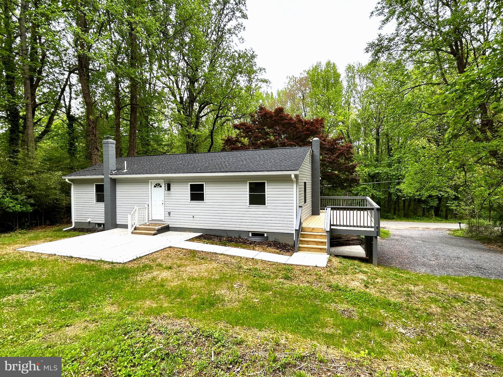 4475 Virginia Avenue Prince Frederick, MD 20678 - Photo 3 of 51 a view of a house with a patio and a yard