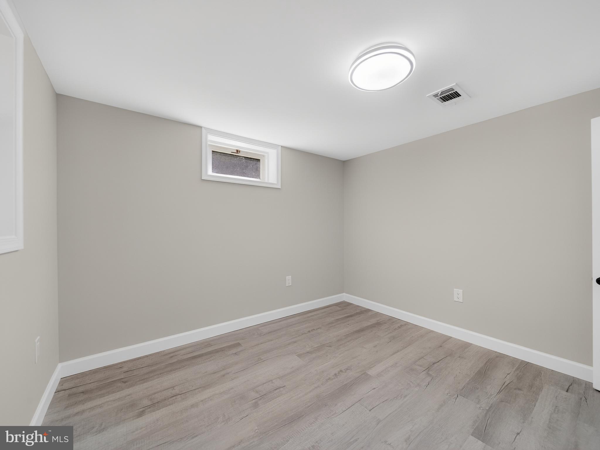 4475 Virginia Avenue Prince Frederick, MD 20678 - Photo 37 of 51 a view of an empty room with wooden floor and window