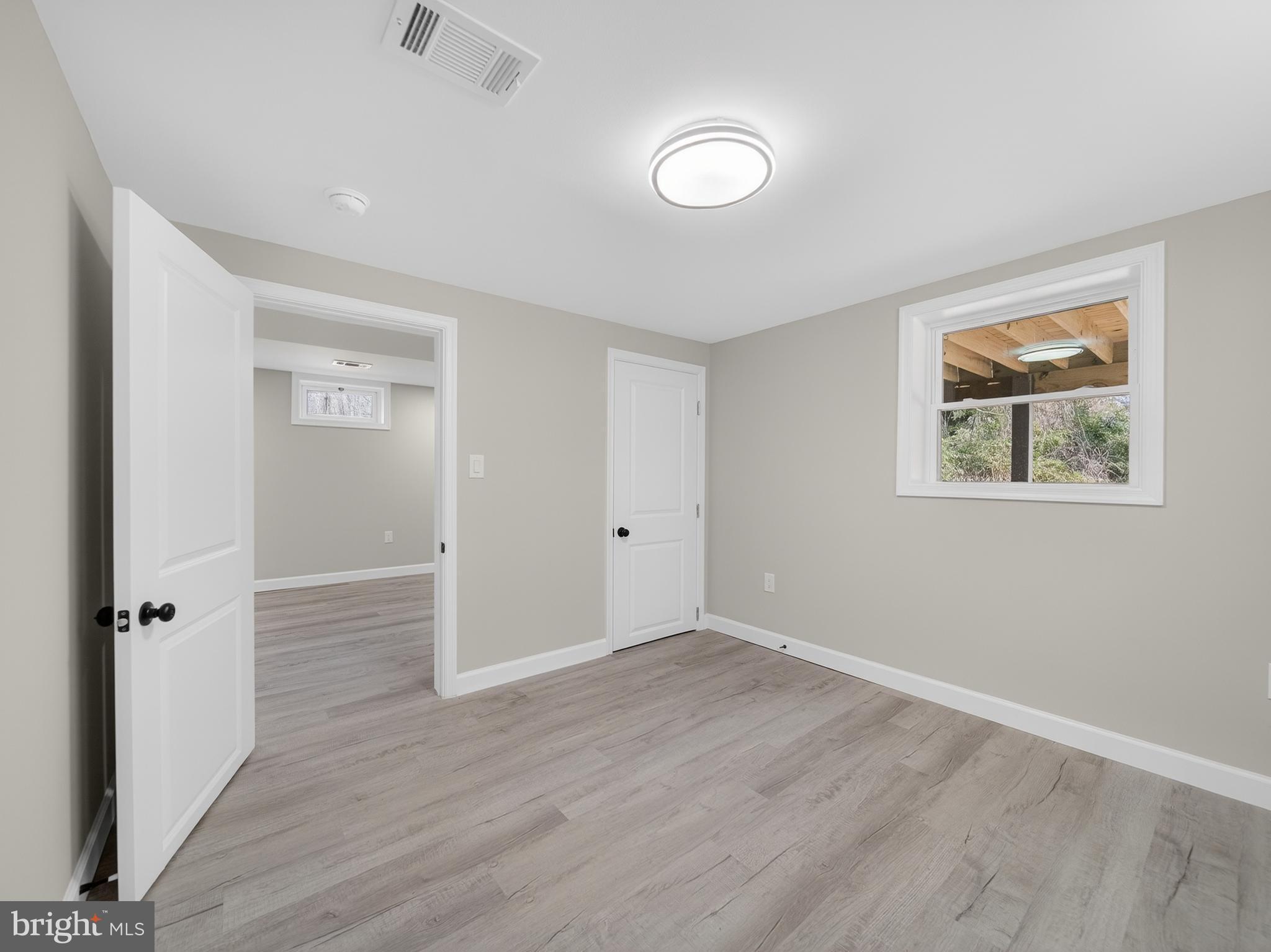 4475 Virginia Avenue Prince Frederick, MD 20678 - Photo 39 of 51 wooden floor in an empty room with a window