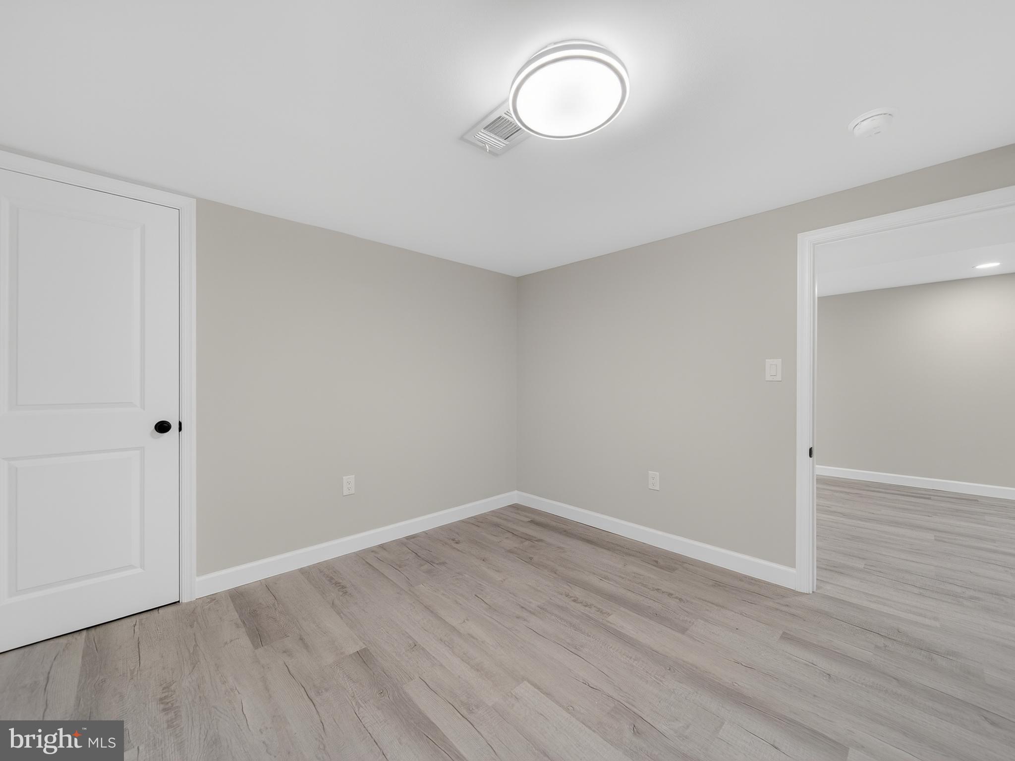 4475 Virginia Avenue Prince Frederick, MD 20678 - Photo 43 of 51 a view of a room with wooden floor and white walls