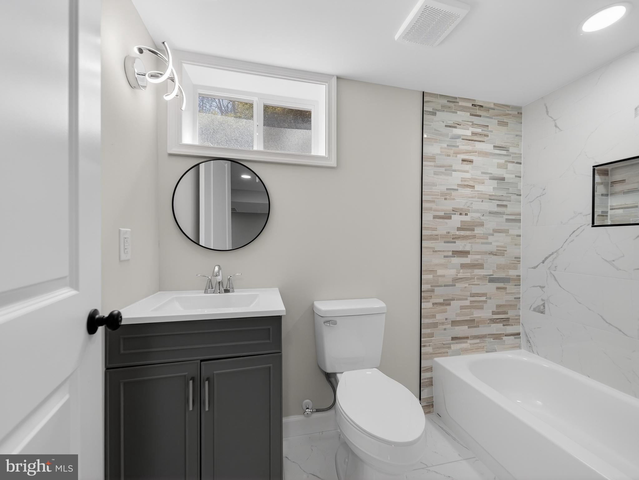 4475 Virginia Avenue Prince Frederick, MD 20678 - Photo 45 of 51 a bathroom with a toilet sink and mirror