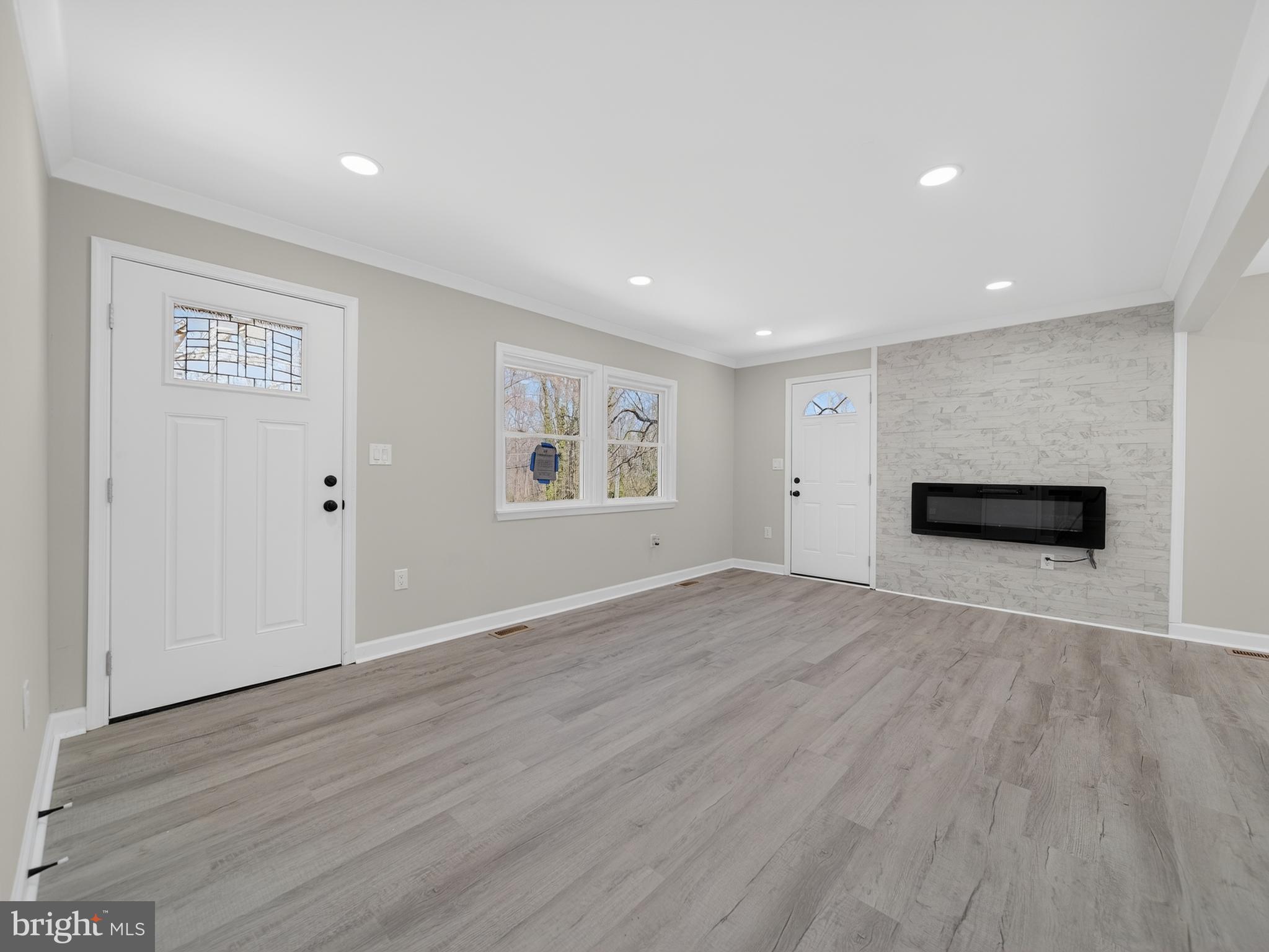 4475 Virginia Avenue Prince Frederick, MD 20678 - Photo 7 of 51 a view of an empty room with wooden floor and windows