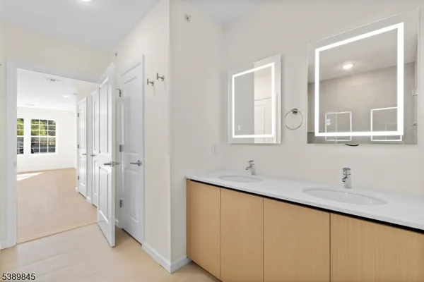 a bathroom with a double vanity sink and mirror