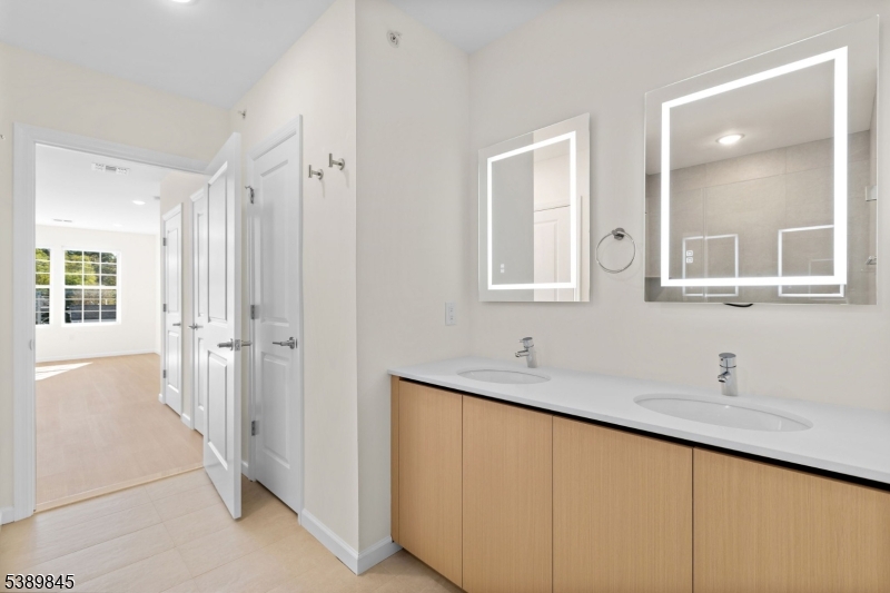 70 Ridgedale Avenue, Unit 310 Morristown, NJ 07960 - Photo 12 of 21 a bathroom with a double vanity sink and mirror