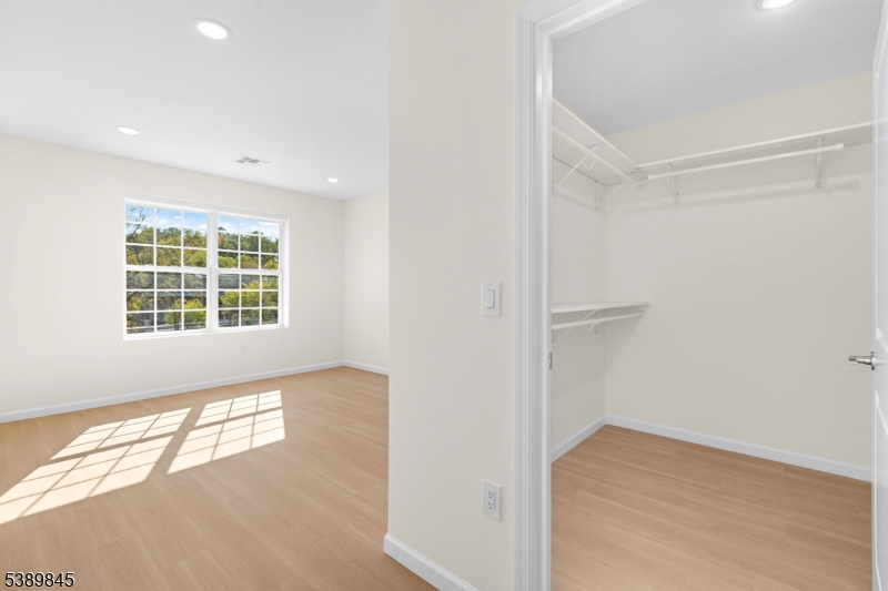 70 Ridgedale Avenue, Unit 310 Morristown, NJ 07960 - Photo 14 of 21 an empty room with wooden floor and windows