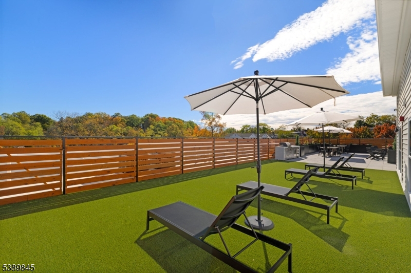 70 Ridgedale Avenue, Unit 310 Morristown, NJ 07960 - Photo 19 of 21 a view of a tennis ground with a table and chairs