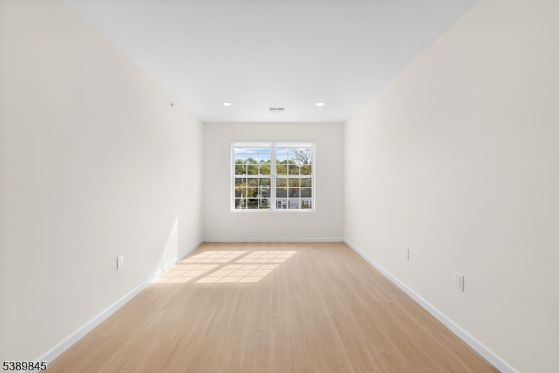 70 Ridgedale Avenue, Unit 310 Morristown, NJ 07960 - Photo 5 of 21 an empty room with windows