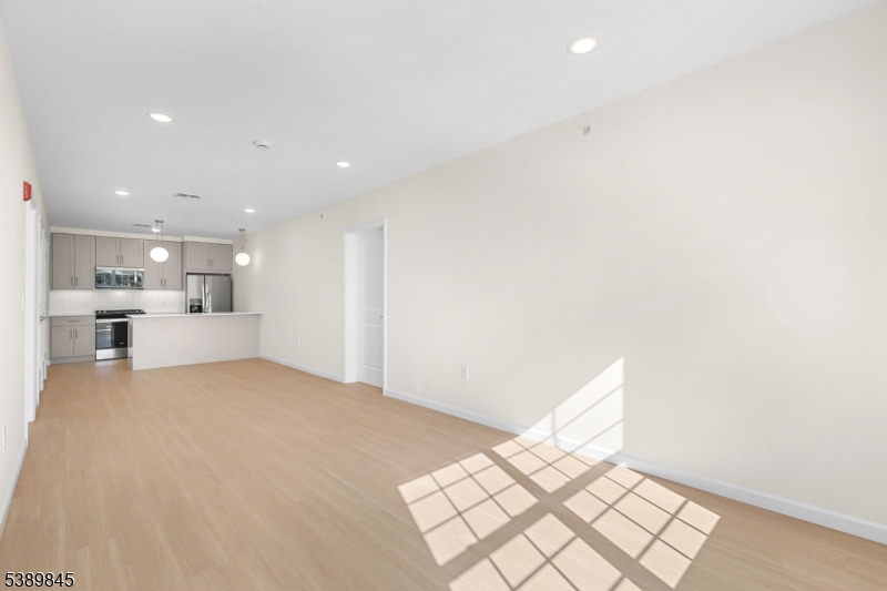 70 Ridgedale Avenue, Unit 310 Morristown, NJ 07960 - Photo 7 of 21 a view of kitchen and empty room with wooden floor