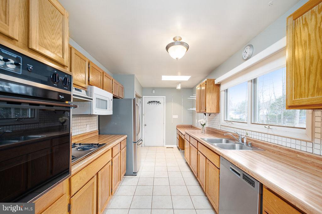 3915 Doran Road Fredericksburg, VA 22407 - Photo 44 of 57 a large kitchen with stainless steel appliances granite countertop a sink and cabinets
