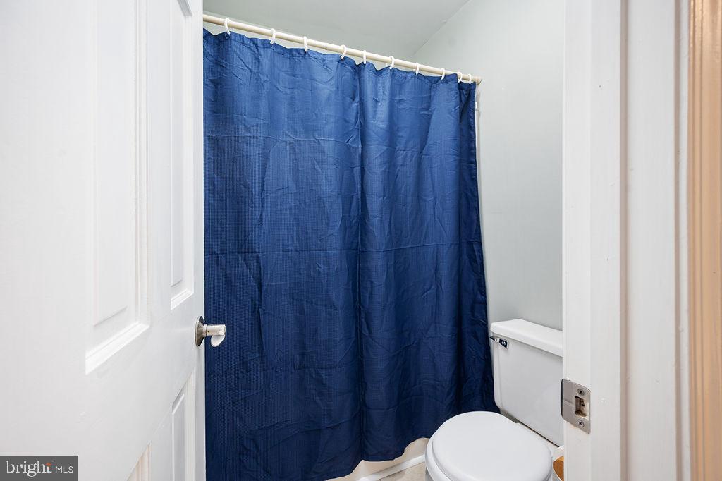 3915 Doran Road Fredericksburg, VA 22407 - Photo 54 of 57 a white toilet sitting next to a wooden cabinet