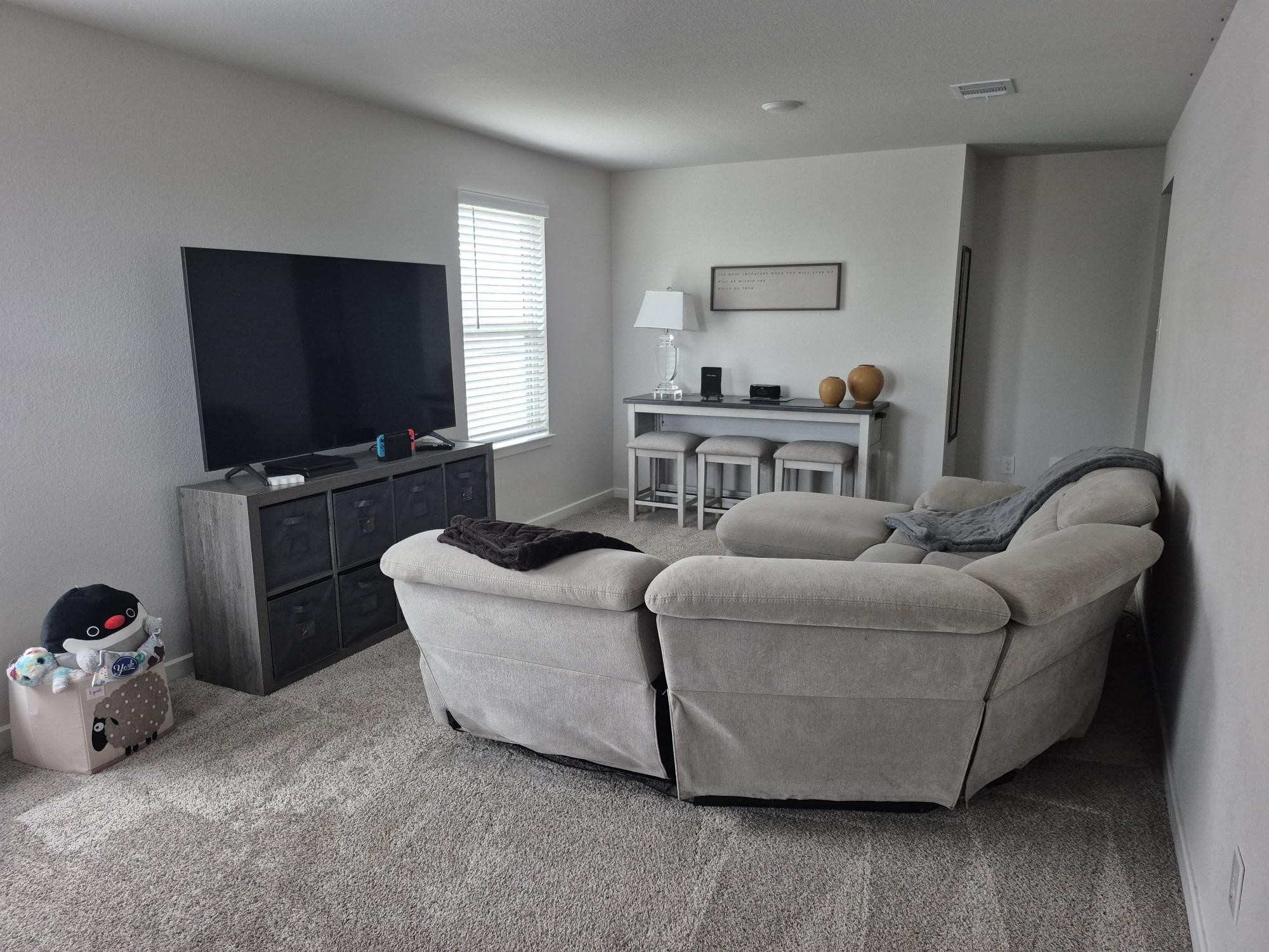 15814 Weston Ridge Drive Humble, TX 77346 - Photo 15 of 43 a living room with furniture and a flat screen tv