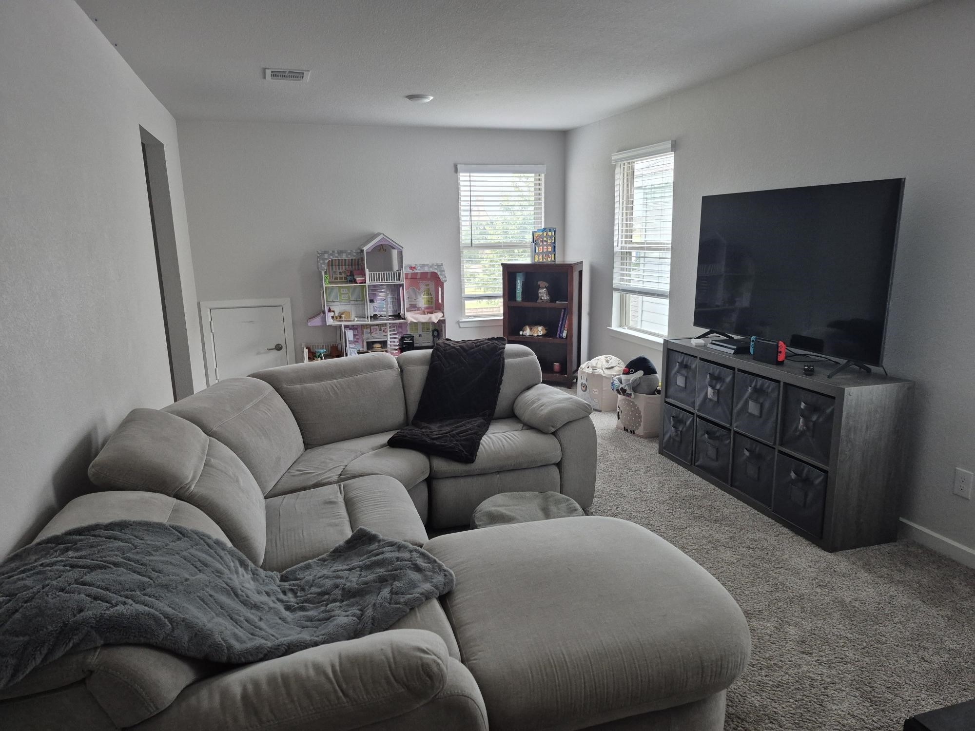 15814 Weston Ridge Drive Humble, TX 77346 - Photo 16 of 43 a living room with furniture and a flat screen tv
