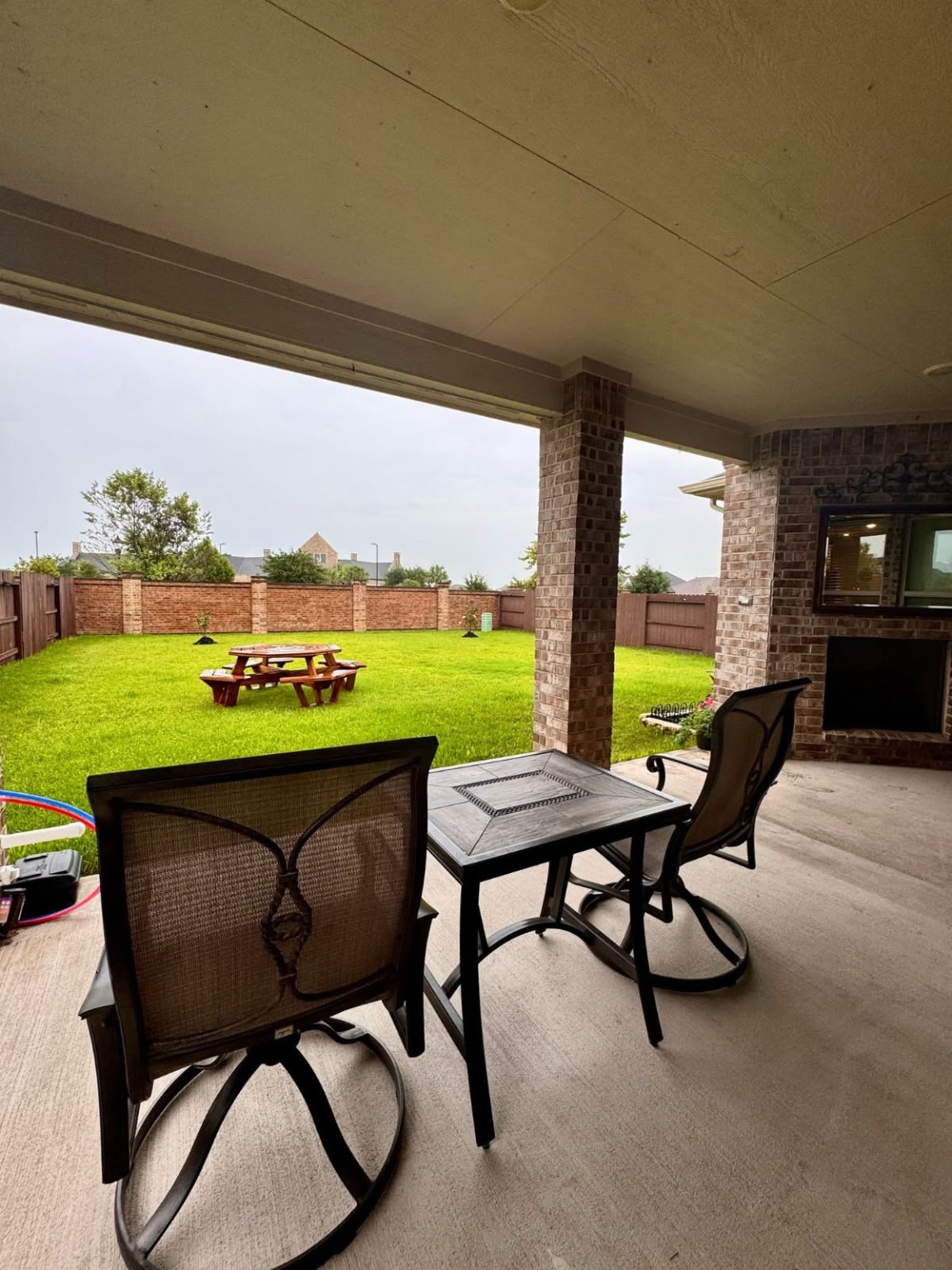 15814 Weston Ridge Drive Humble, TX 77346 - Photo 22 of 43 a view of a chairs and table in patio and a yard