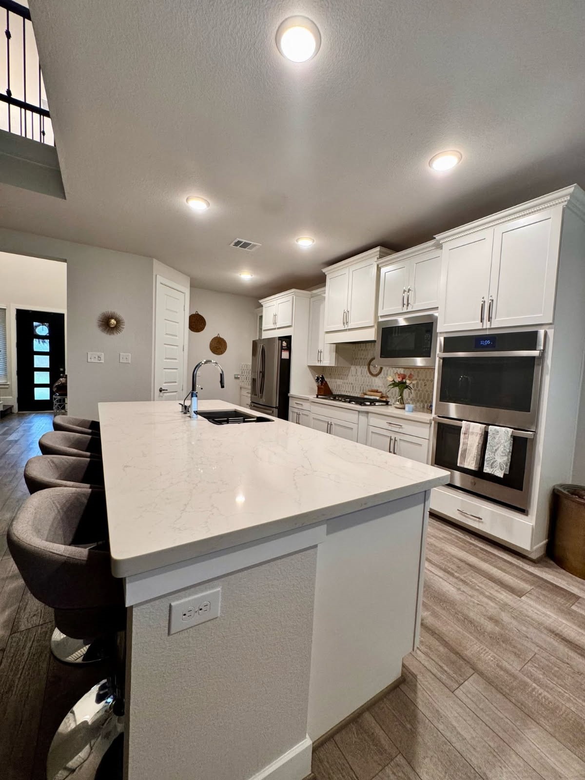15814 Weston Ridge Drive Humble, TX 77346 - Photo 23 of 43 a large white kitchen with kitchen island a stove a sink a refrigerator and cabinets