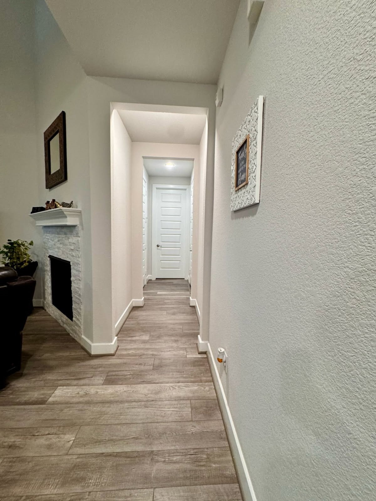 15814 Weston Ridge Drive Humble, TX 77346 - Photo 26 of 43 a view of a hallway with wooden floor and a fireplace