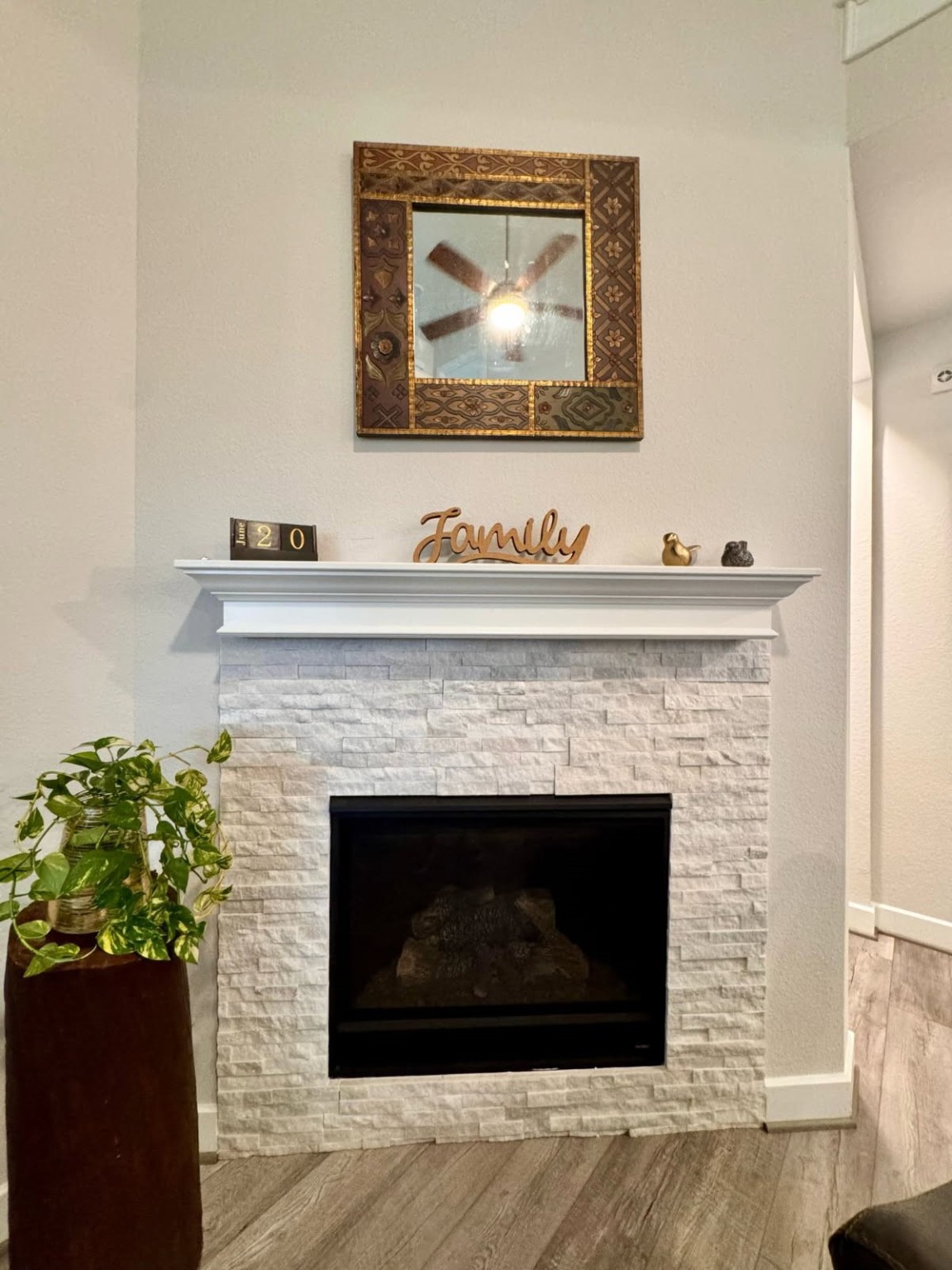 15814 Weston Ridge Drive Humble, TX 77346 - Photo 6 of 43 a living room with a fireplace and a wooden floor
