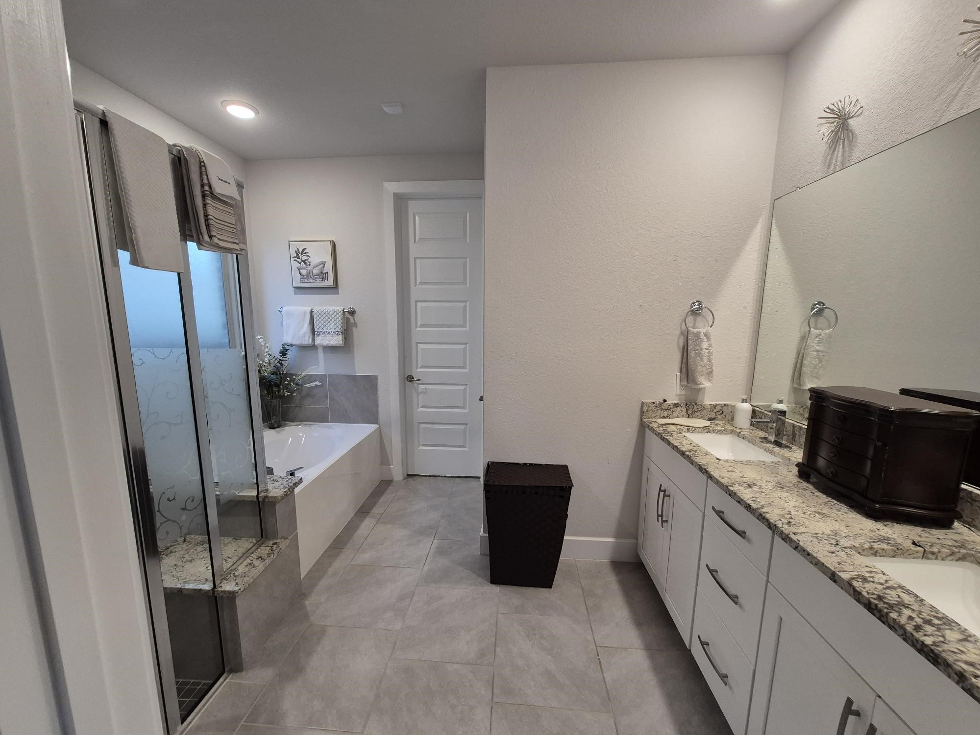 15814 Weston Ridge Drive Humble, TX 77346 - Photo 10 of 43 a large bathroom with a granite countertop tub sink a mirror and a shower