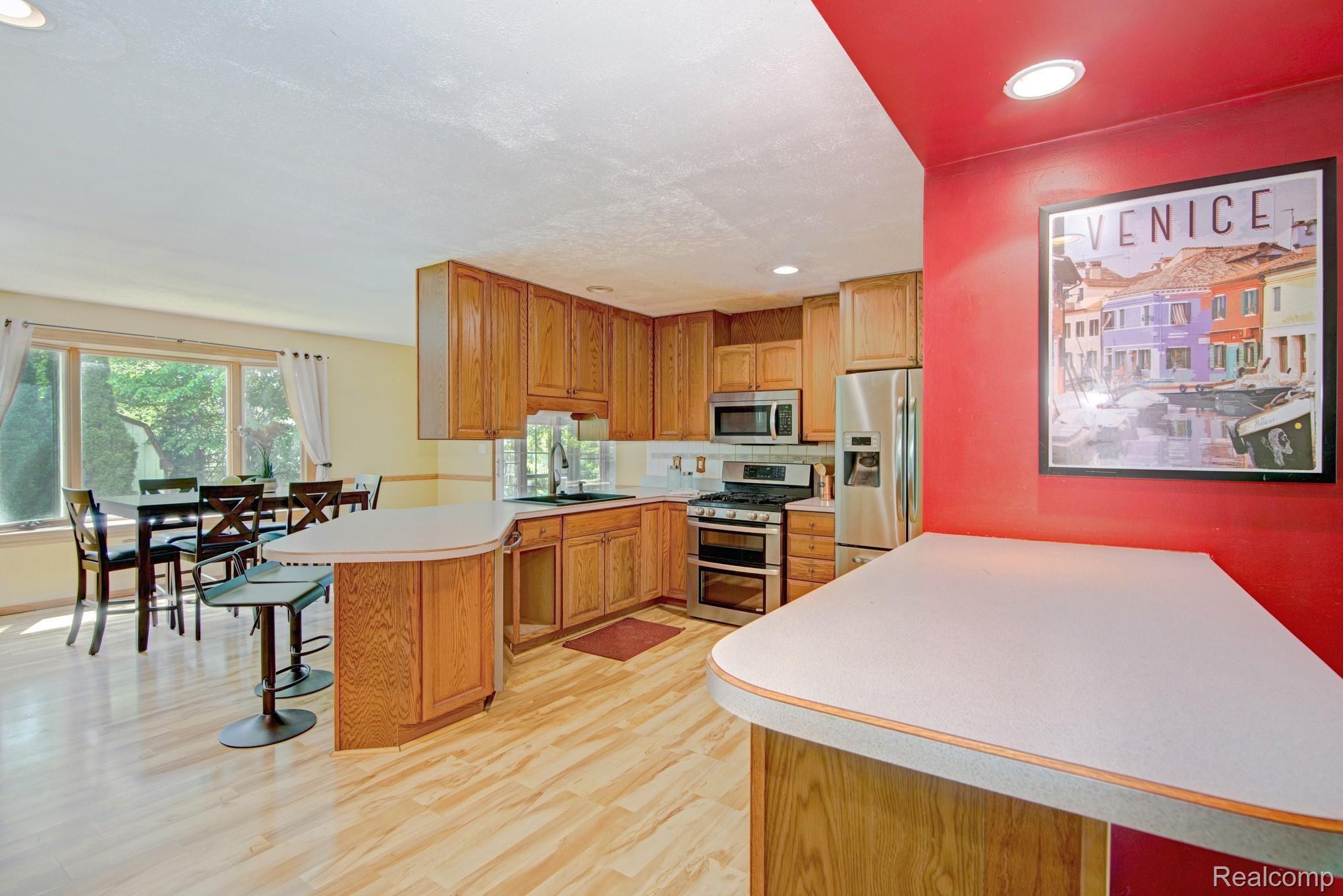 2801 West Commerce Road Milford, MI 48380 - Photo 26 of 27 Open floor plan kitchen with two breakfast bars,stainless steel appliances, and plenty of cabinets for storage