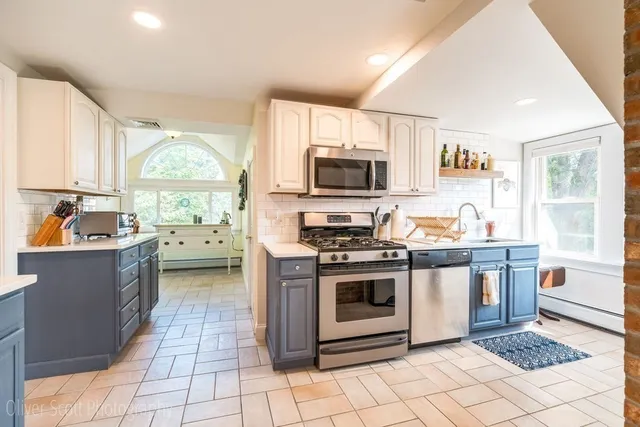a kitchen with a stove a sink and a microwave