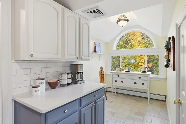 a kitchen with a cabinets and window
