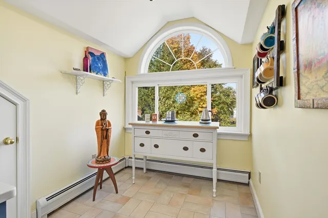 a view of baby room with furniture and a window