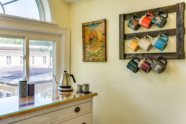 a room with wall paintings on the wall and a window