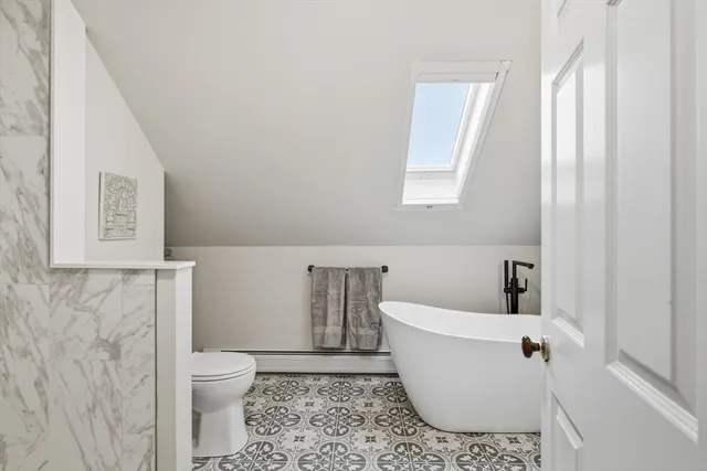 a bathroom with a toilet a sink and bathtub