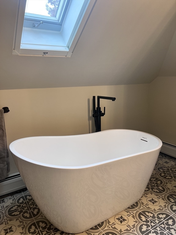 30 Graves Avenue, Unit B Northampton, MA 01060 - Photo 31 of 41 a white tub sitting in a bathroom