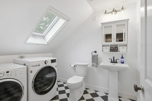a bathroom with a sink mirror and toilet